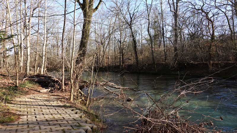 Walking path right impeding the Little Harpeth River Riverbank.