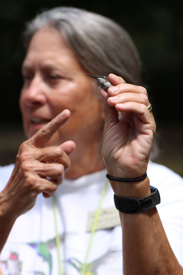 Sandy Bivens holding a hummingbird