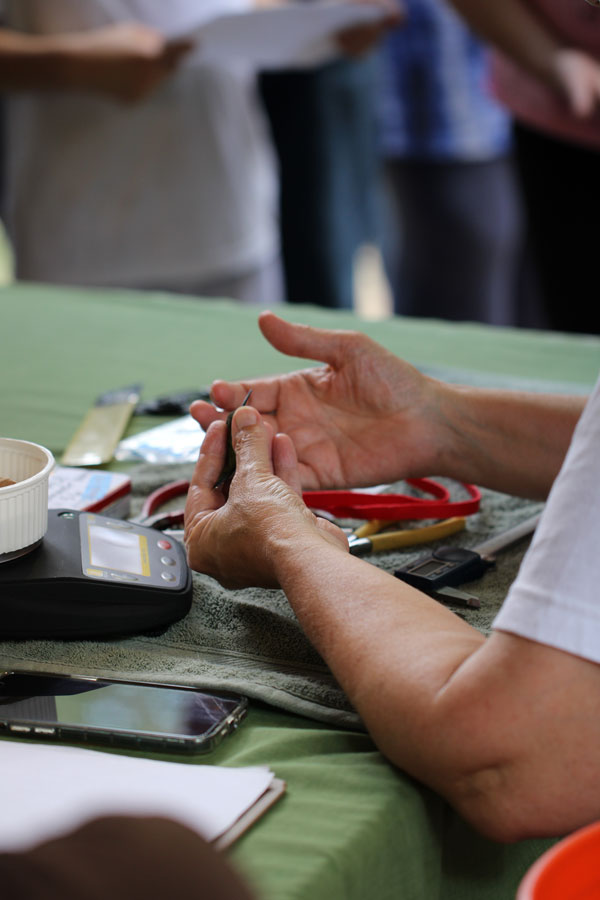 Volunteer holding a hummingbird at the banding table