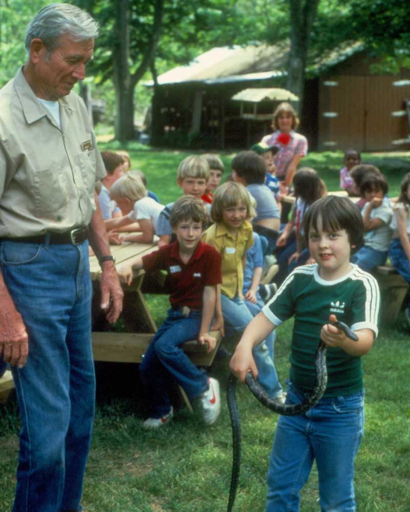 Sandy Bivens holding a hummingbird