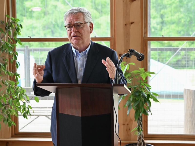 Man in suit speaking at a podium