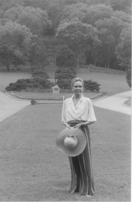 Black and white photo of woman in front of Allée