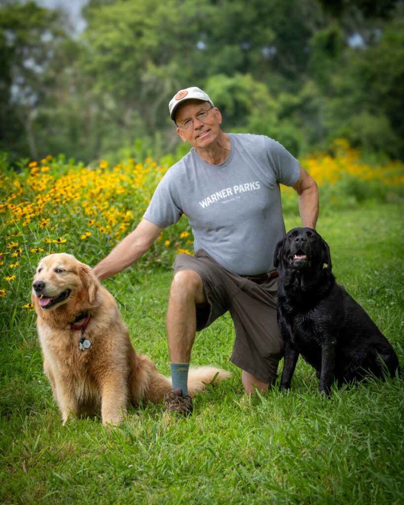 Benji Armistead with his two dogs, Flora and Waylon at Clare's Meadow. Photo by Terry Cook.